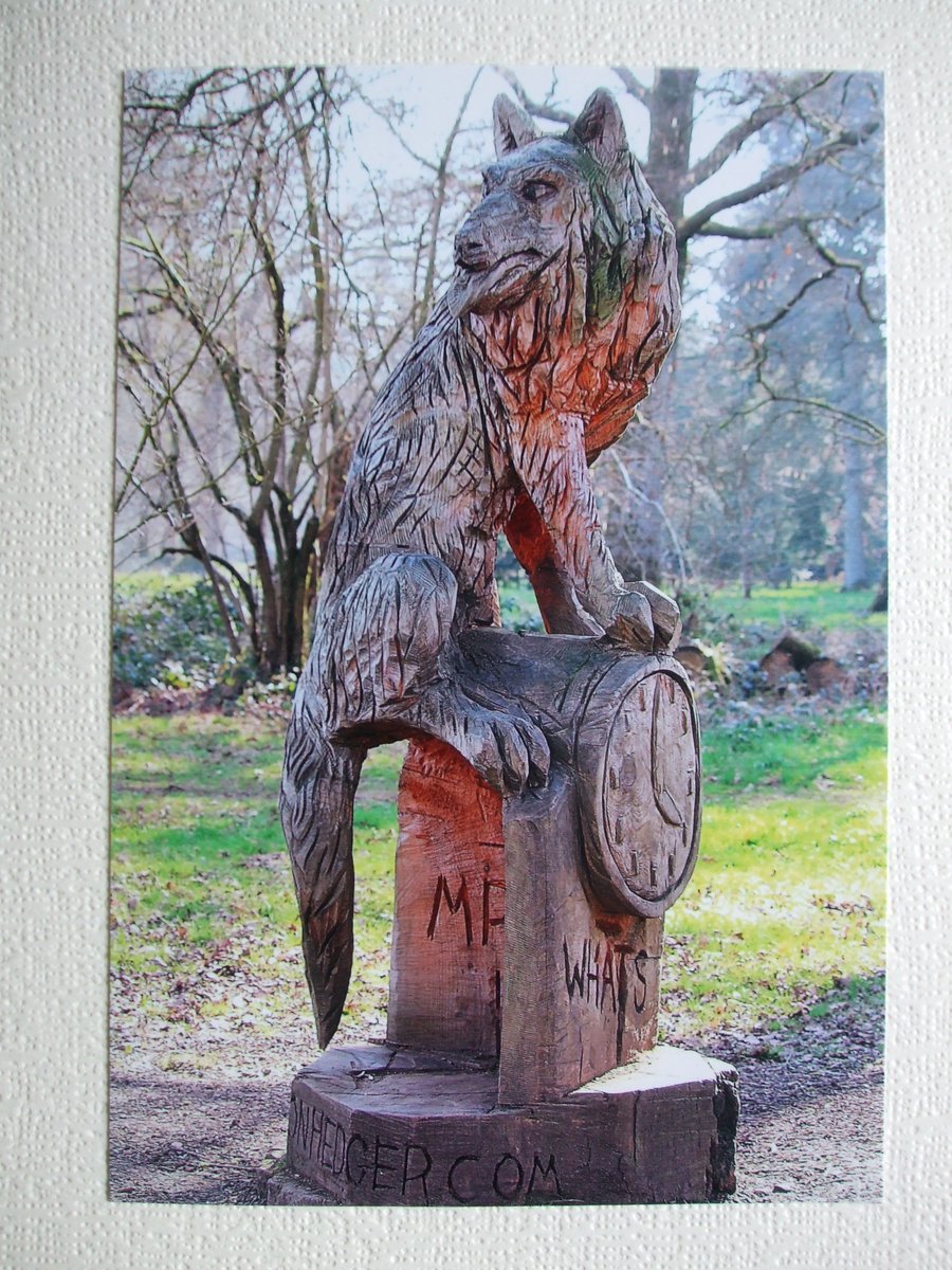 Photographic greetings card of "Mr. Wolf" in chain-saw art.