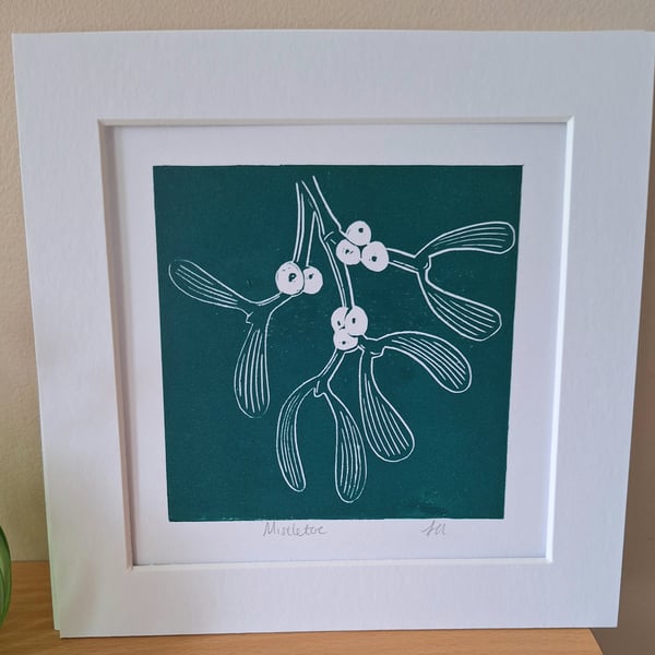 An original handprinted linoprint of a sprig of mistletoe 
