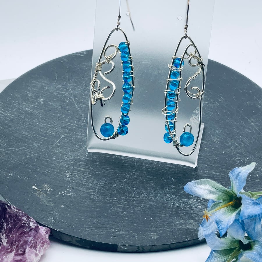 Aqua coloured long drop earrings in silver