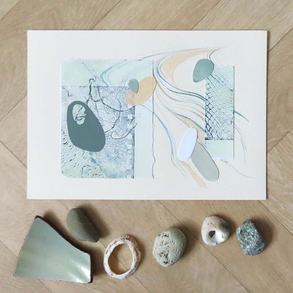 Mixed media collage of pebbles washed up by the tide subtle sage and cream tones