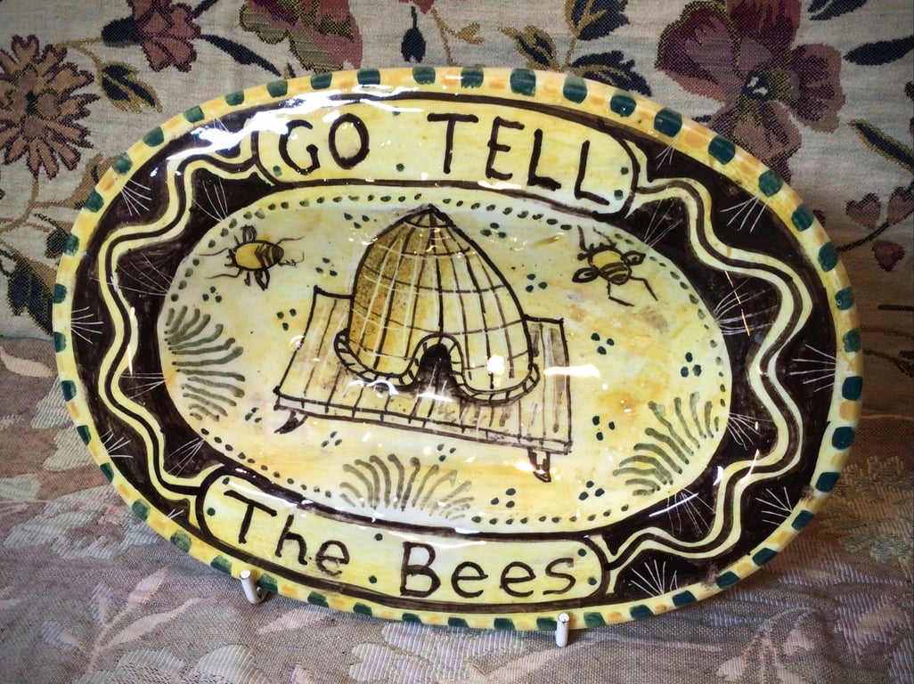Oval slip ware dish with hand painted bee skep