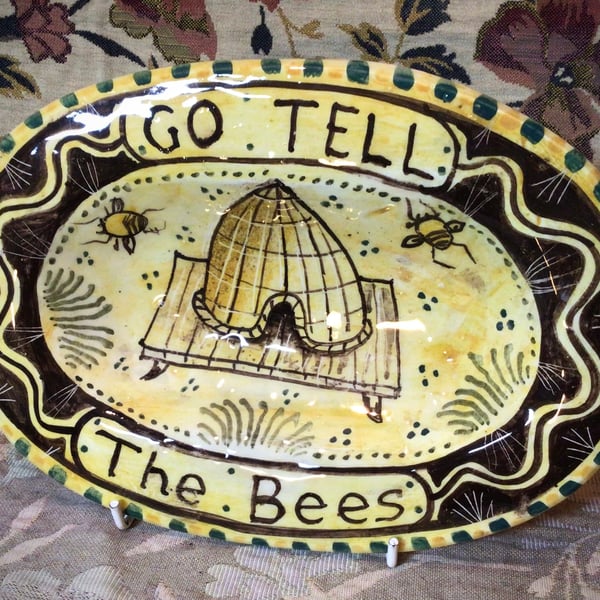 Oval slip ware dish with hand painted bee skep