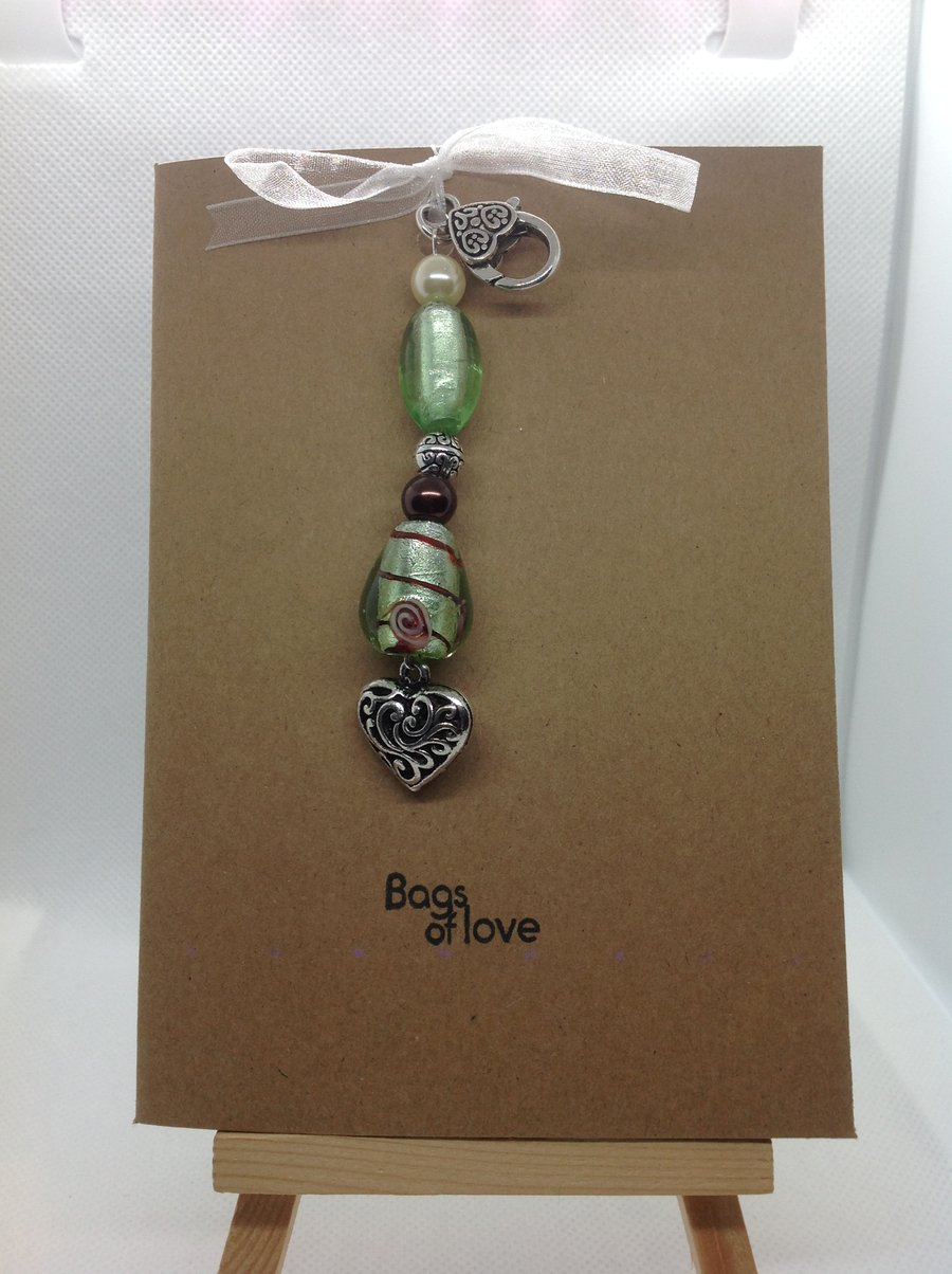 Hand made bag charm attached to a hand stamped greetings card