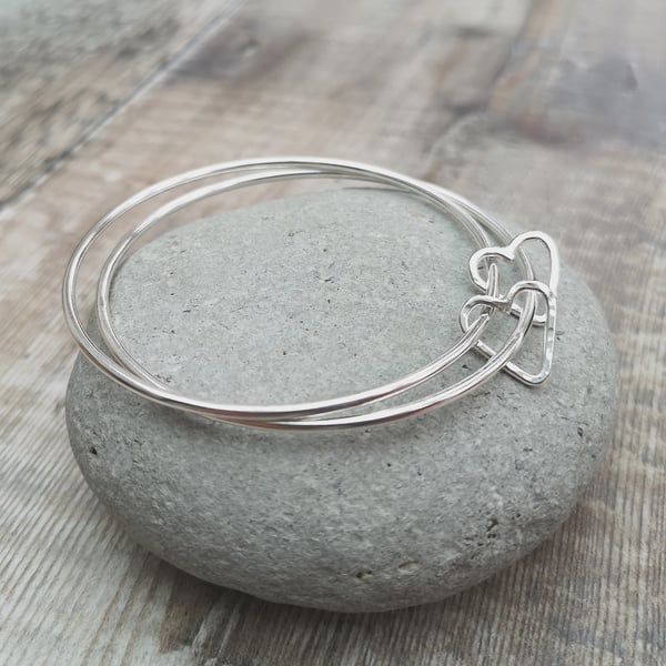 Sterling Silver Bangle with Two Open Love Heart Charms 