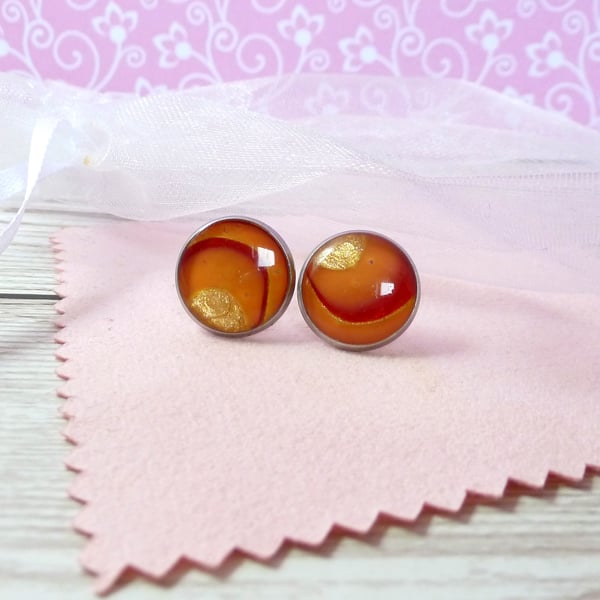 One of a kind orange, gold and red swirl stud earrings. 