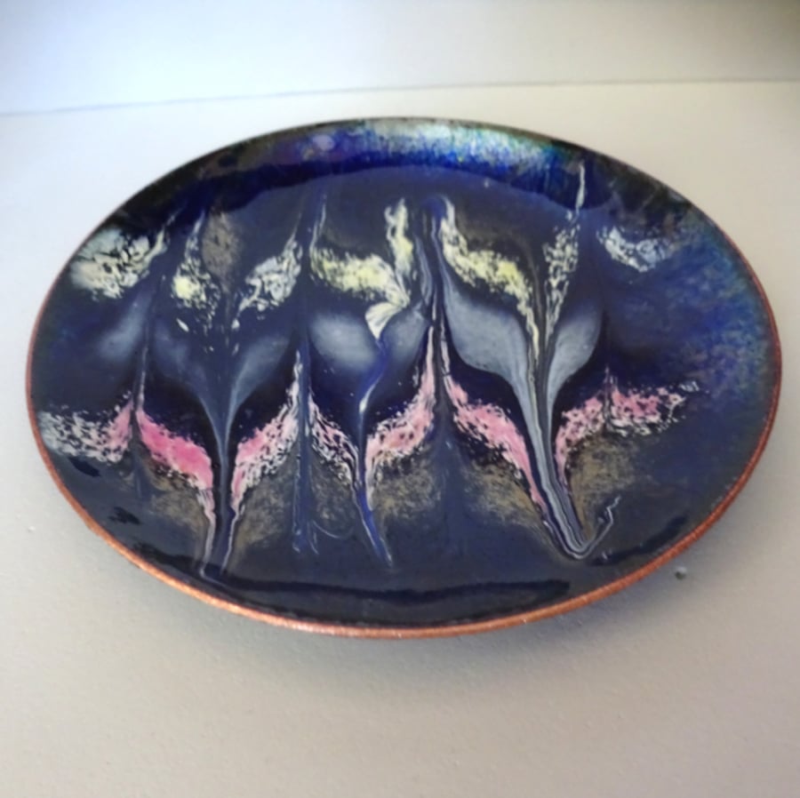 enamelled dish: scrolled white, gold, pink, pale brown on dark blue over clear