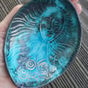 Hand size bowl .With raised mermaid  motif. 