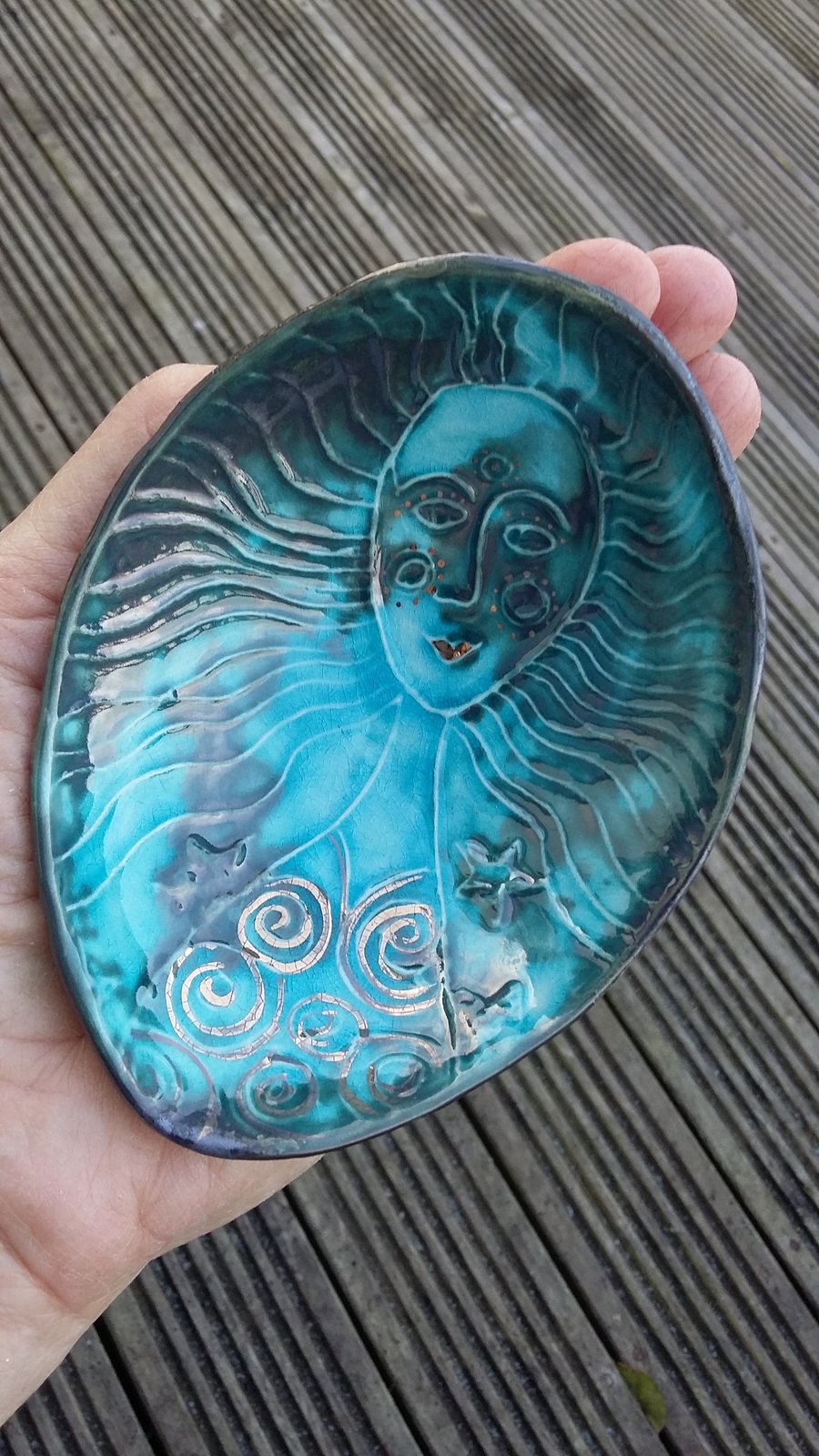 Hand size bowl .With raised mermaid  motif. 