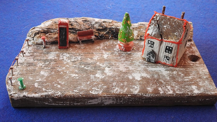 Winter snow scene with little cottage dusted in snow Christmas decoration