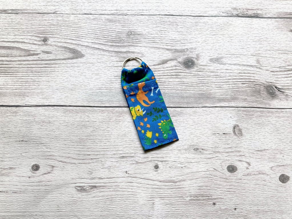 Dinosaurs lip balm blue polycotton fabric keyring. 