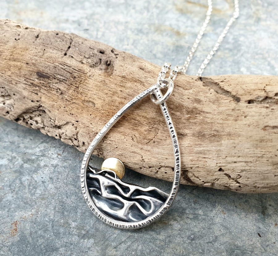 Silver teardrop sun rising over the sea pendant