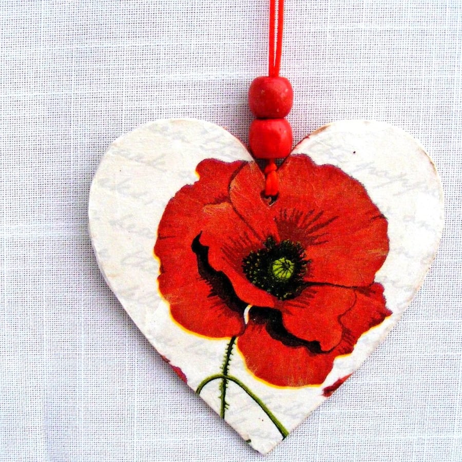 Red poppy decoupaged wooden heart wall decoration.