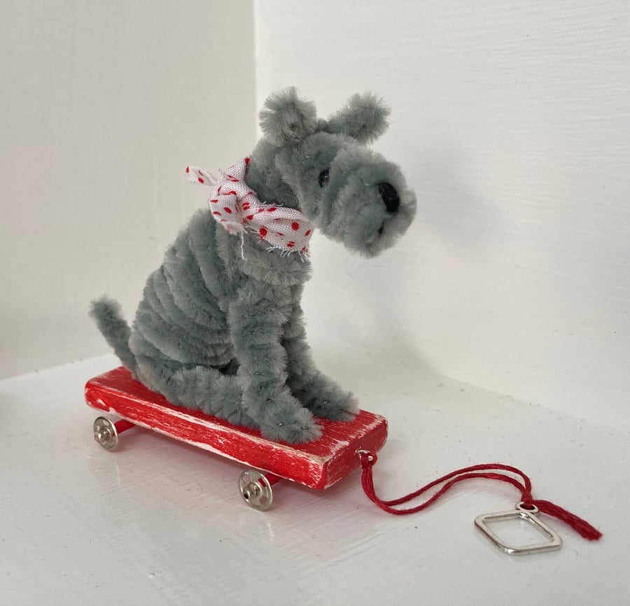 Miniature Terrier on Pull Along Trolley with Wheels. 