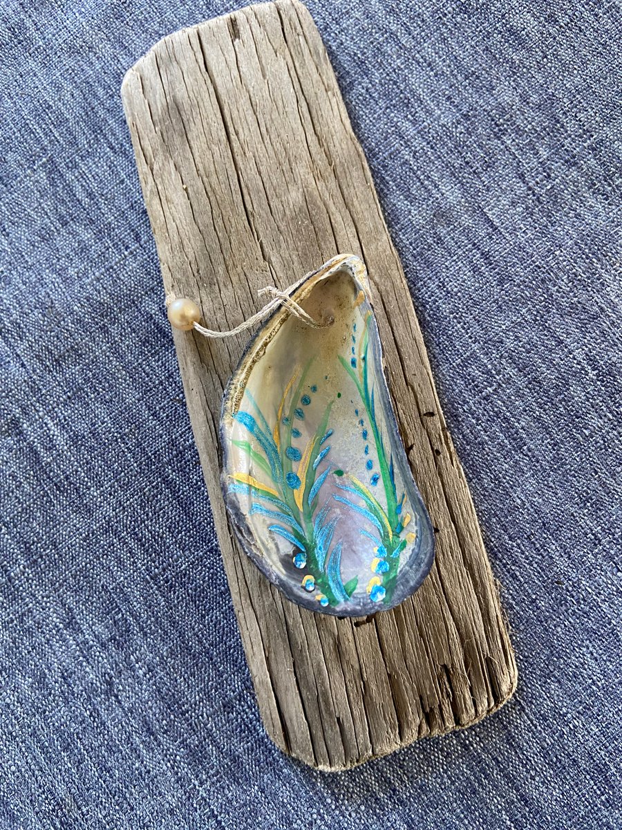 Hand painted mussel shell from an Argyll beach. With a beaded hanger.