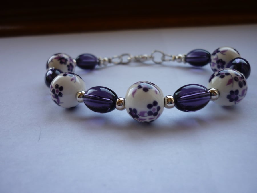 PURPLE, WHITE AND SILVER FLORAL PORCELAIN BRACELET .  1045
