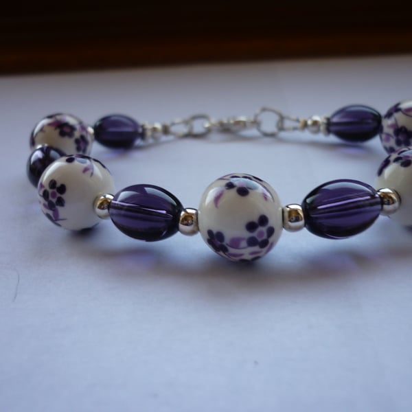 PURPLE, WHITE AND SILVER FLORAL PORCELAIN BRACELET .  1045