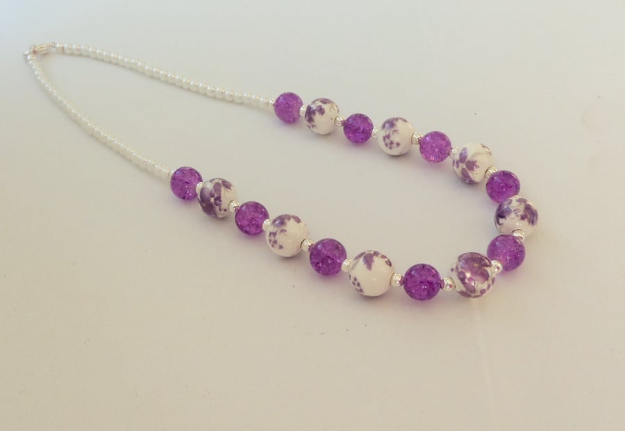 Purple and white ceramic and glass bead necklace.