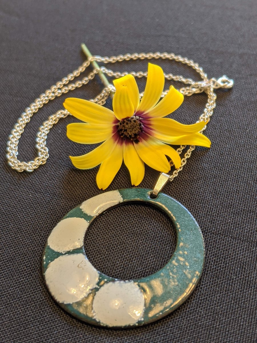 Enamel on copper hung on solid silver chain and clasp with a silver bail.