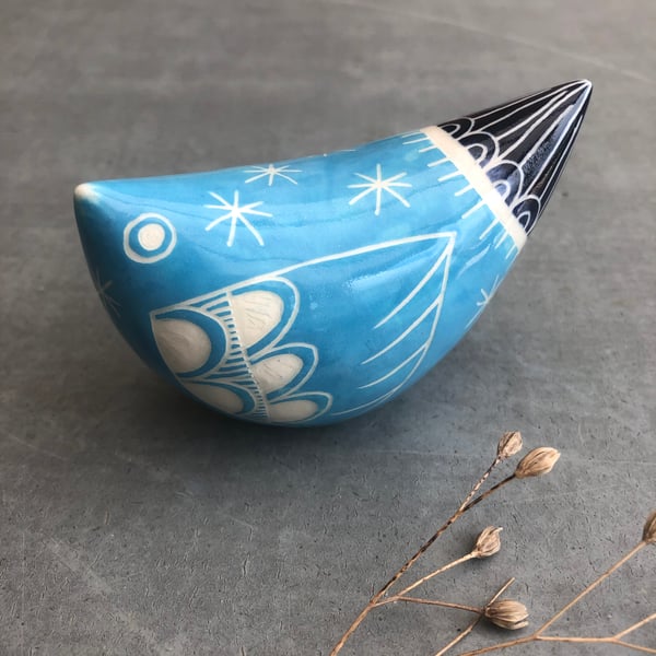 Turquoise and dark blue ceramic bird .