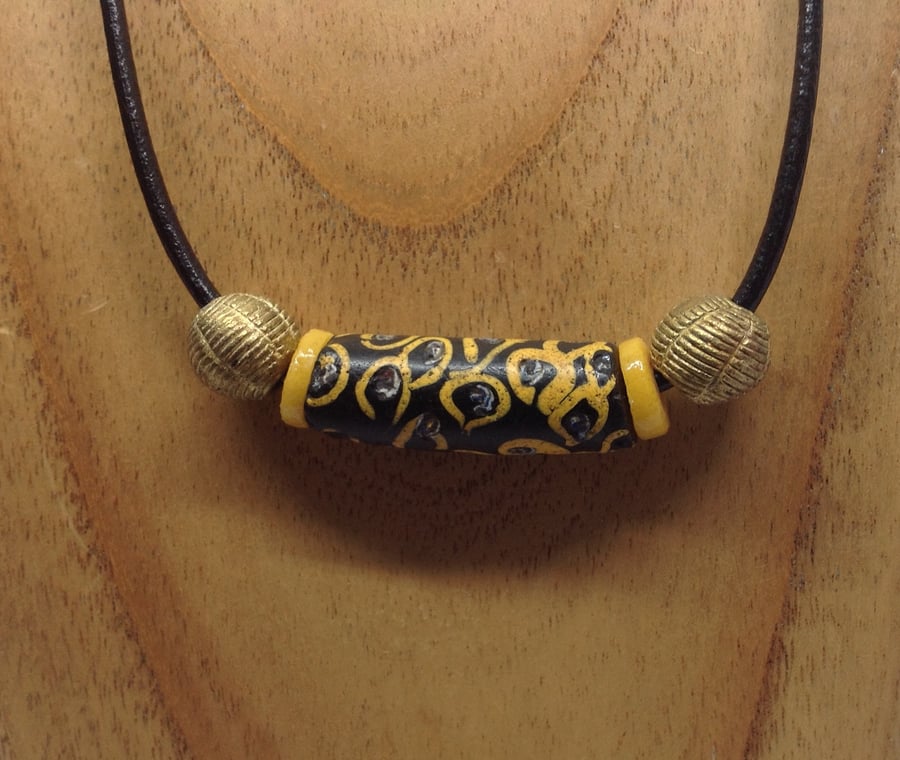 A unisex cord necklace with giant old African trade bead 