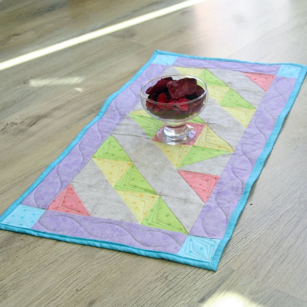 Handmade Quilted table runner with pale spring fabrics and scattered stars.