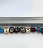 Handmade brown, ivory and turquoise patterned lamp work glass beads - Image 3