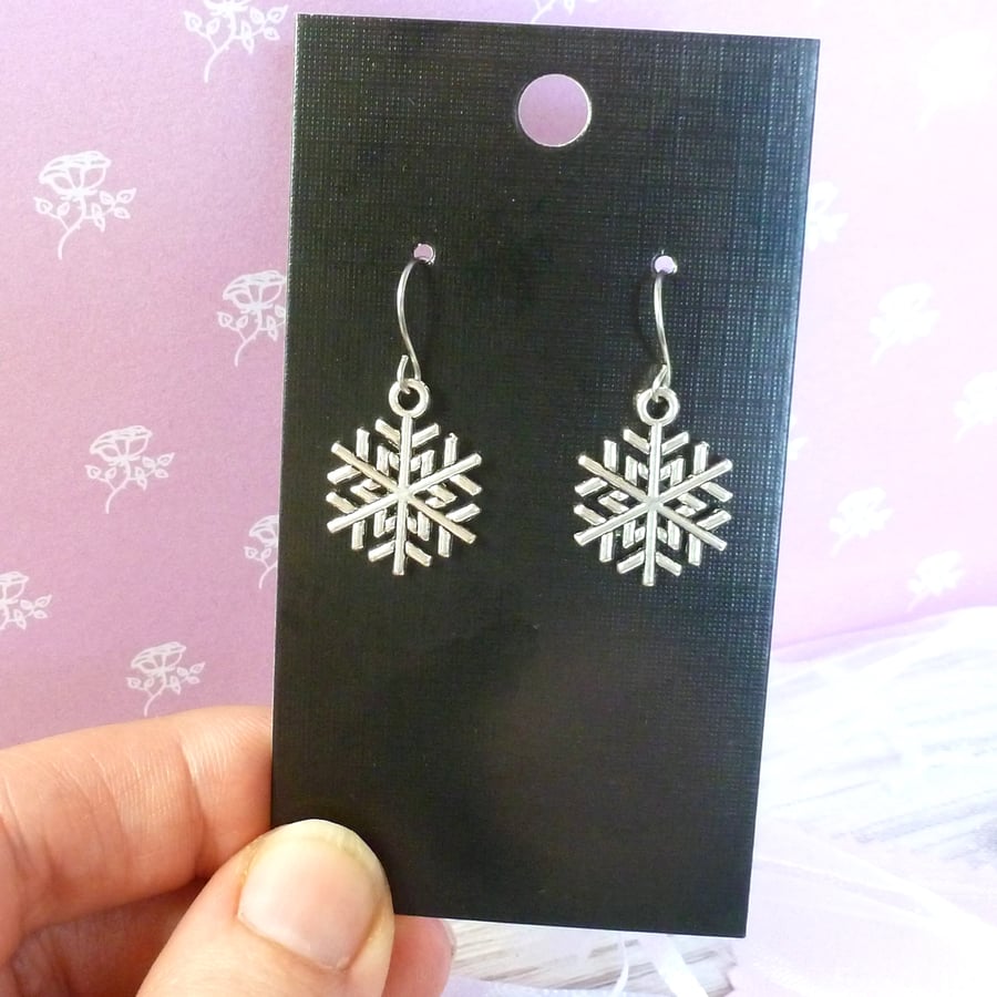 Shiny silver metal snowflake earrings on steel wires, 