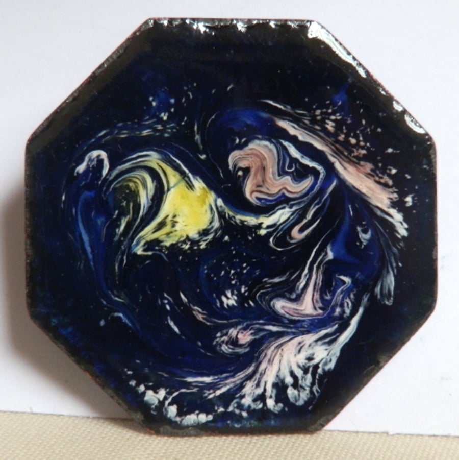 yellow. purple and white scrolled over dark blue - brooch