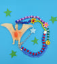 Chunky beaded necklace with up-cycled dinosaur charm 