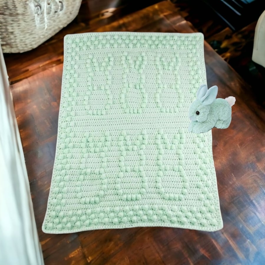 Crochet baby blanket in pale green with puff bobbly bunny pattern