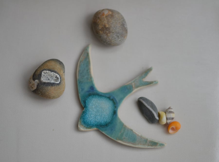 Swifts glazed in blues and turquoise designed to hang on the wall