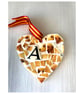 A heart shaped pendant with a Golden Labrador theme.