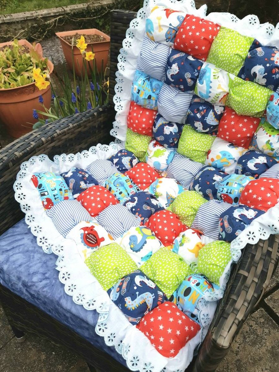Cot quilts in vibrant dinosaur or pig puff ball patchwork fabric