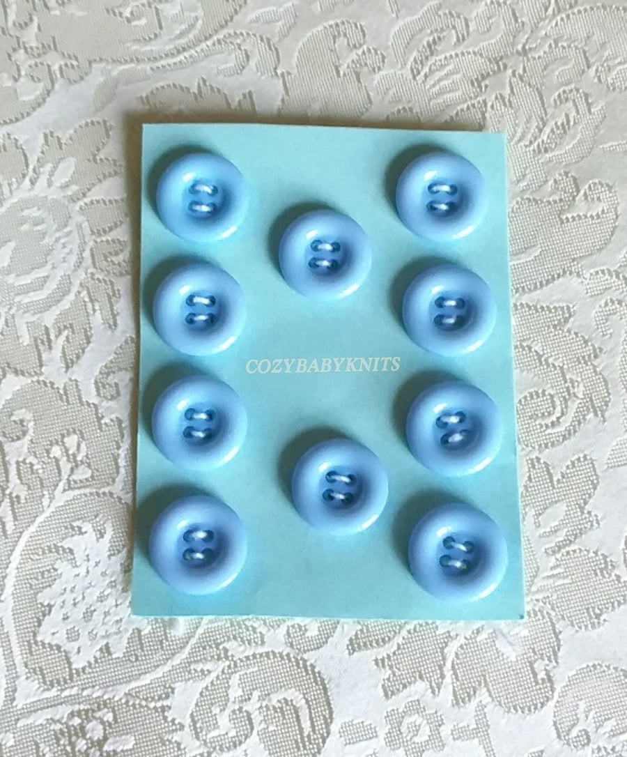 18MM PALE BLUE ROUND BUTTONS WITH FOUR HOLES FOR ATTACHING 