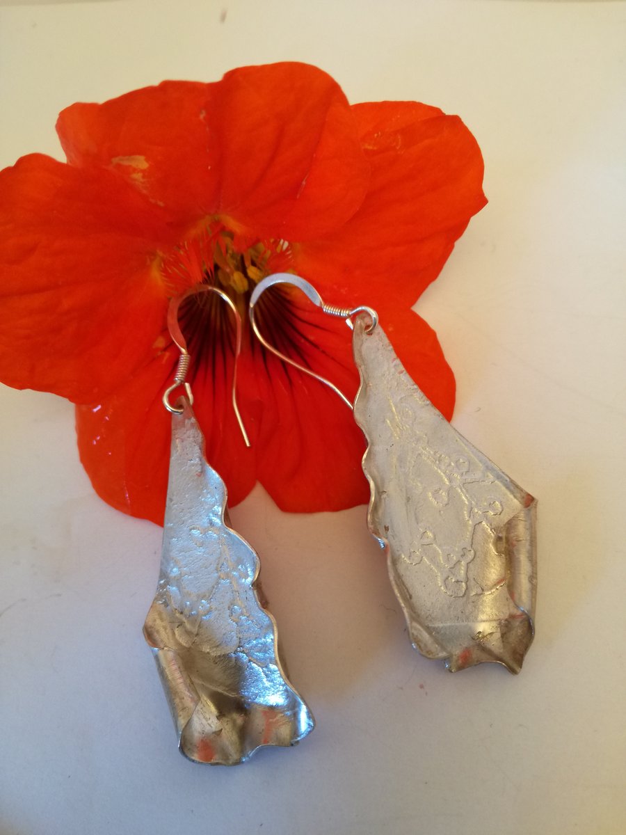 Beautiful silver seed impressed sail shaped earrings