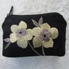 Black purse with pale yellow flowers