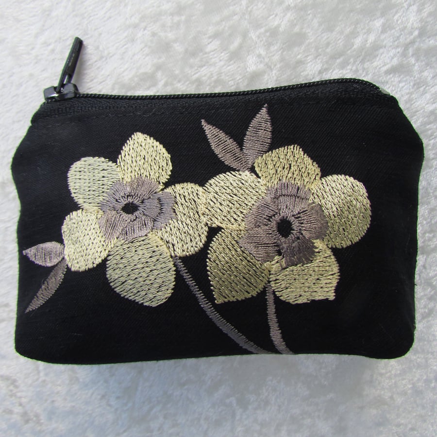 Black purse with pale yellow flowers