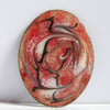 black and white scrolled on red over clear enamel - brooch