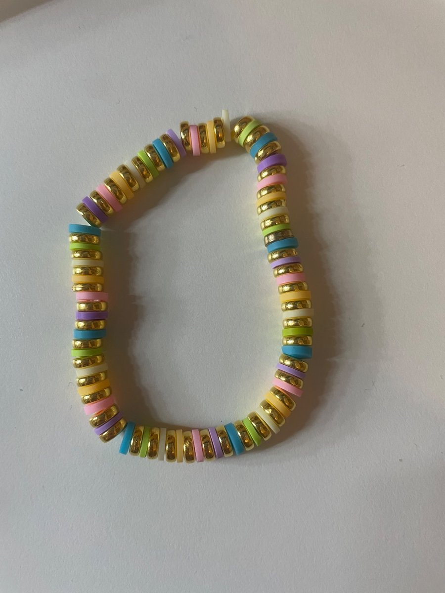A cute bracelet with a pastel rainbow and gold beads!!!