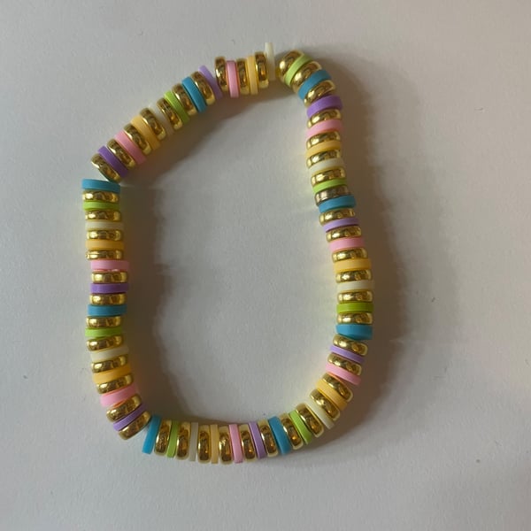 A cute bracelet with a pastel rainbow and gold beads!!!