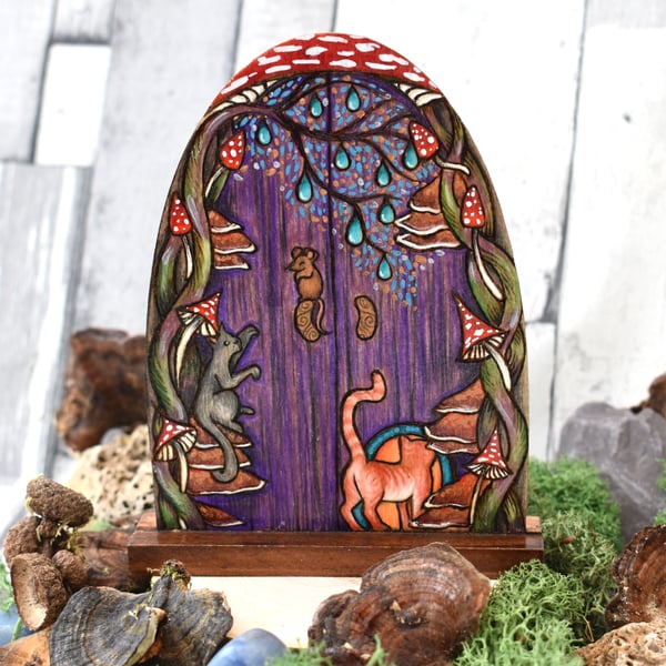 Purple fairy door with cats and mouse. Pyrography decoration.