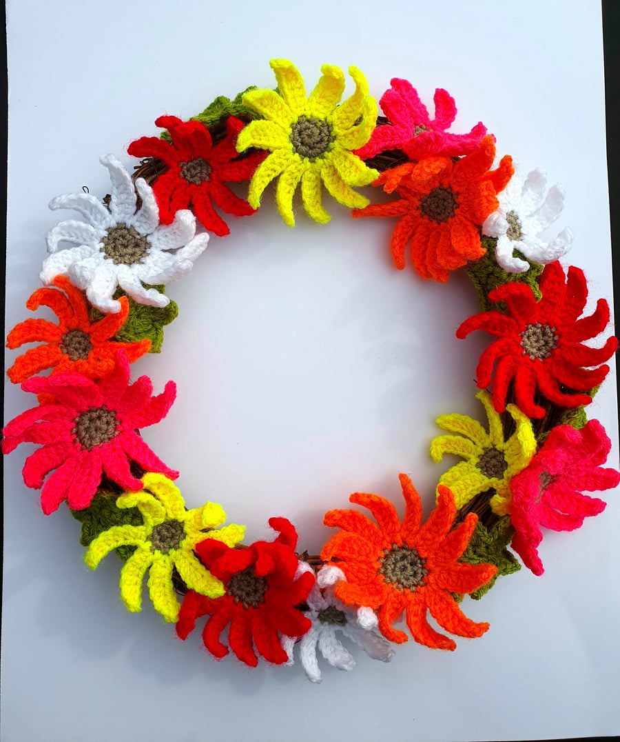 Crocheted floral wreath, 25cm in diameter. Vibrant handmade gerbera flowers.