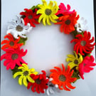 Crocheted floral wreath, 25cm in diameter. Vibrant handmade gerbera flowers.