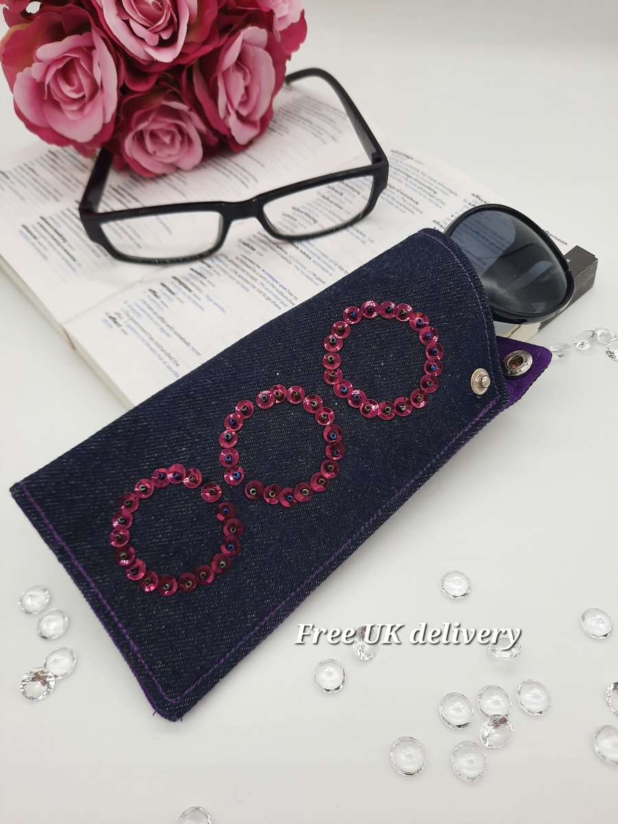 Glasses case, denim, pink circles and purple lining. 