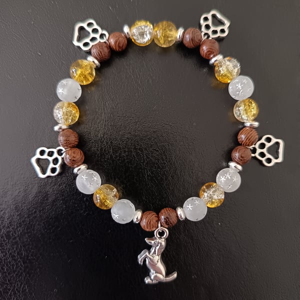 Elasticated beaded bracelet with silver dog and paw print charms 
