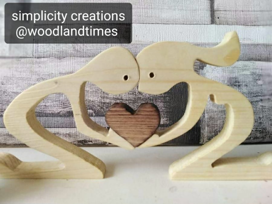 Man and woman holding heart, wooden couple with heart, valentines, anniversary