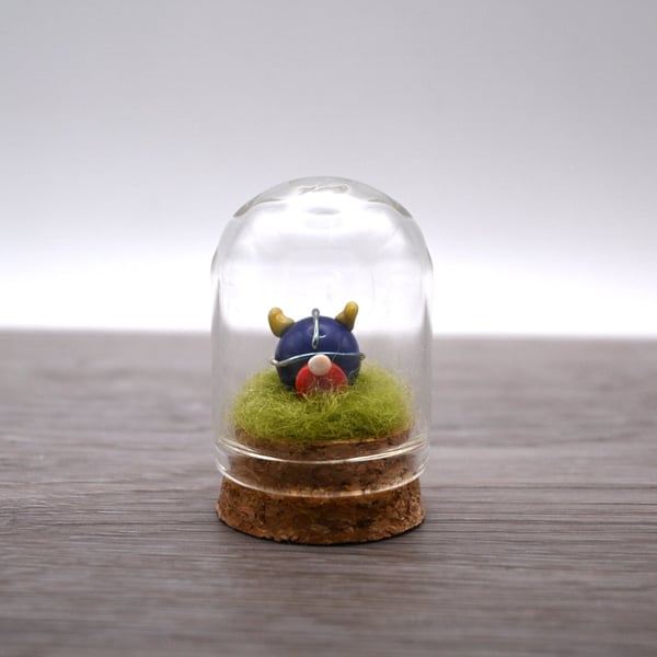 small glass viking figure in cloche jar