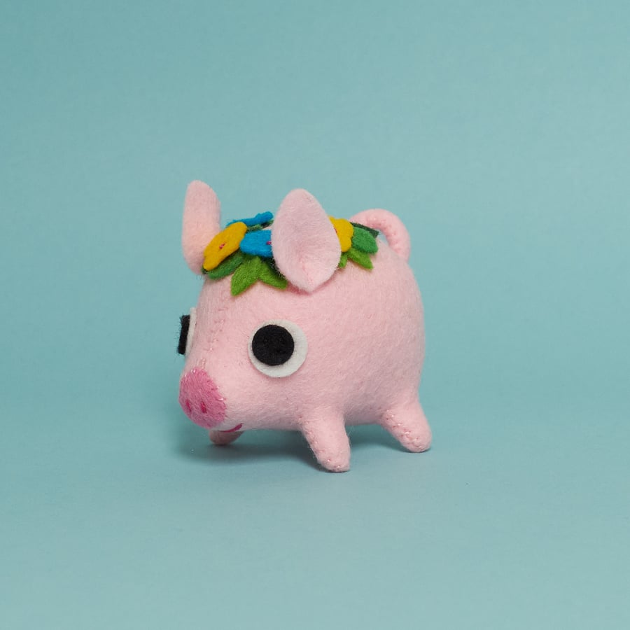 Pink felt pig ornament with a flower crown