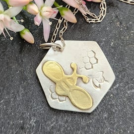 Hexagonal silver pendant with brass bee