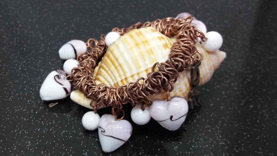 BR15Bungee style bracelet  on antique copper colour chain link with heart beads.